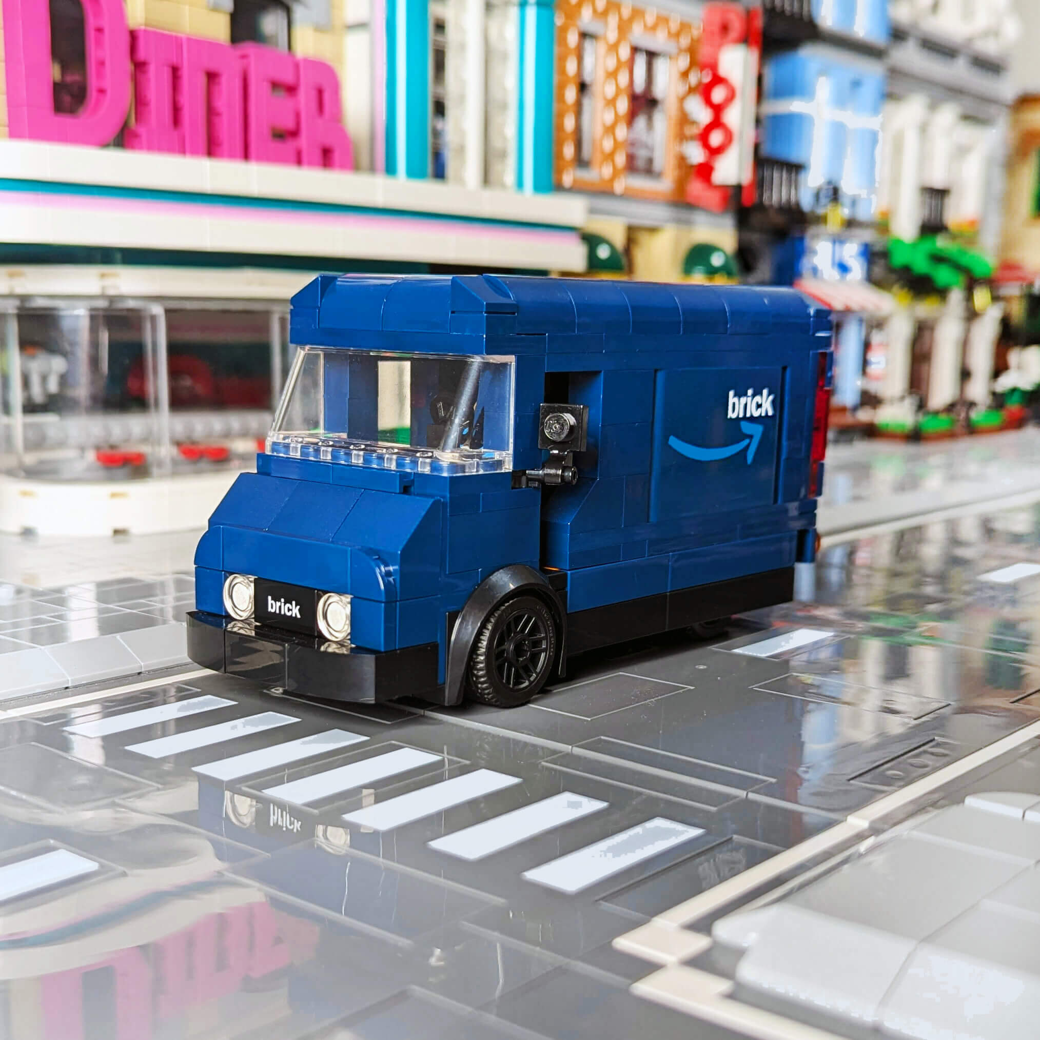 Blue custom truck made with LEGO® with 'brick' branding on a reflective surface